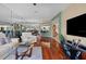 Spacious living room featuring hardwood floors, mirrored walls, and modern decor at 722 Pinellas Bayway S # 102, St Petersburg, FL 33715