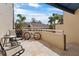 Sunny patio features seating, a grill, and a bicycle at 722 Pinellas Bayway S # 102, St Petersburg, FL 33715