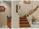 Staircase with carpeted steps, a white railing, and an adjacent laundry area at 722 Pinellas Bayway S # 102, St Petersburg, FL 33715