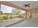 Screened patio provides scenic backyard and pond views with a ceiling fan for relaxed outdoor living at 11606 Tropical Isle Ln, Riverview, FL 33579