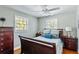 Comfortable bedroom filled with natural light, featuring a ceiling fan and dresser at 4528 S Gaines Rd, Tampa, FL 33611