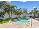 Beautiful backyard pool surrounded by lush landscaping and a white fence, creating a private oasis at 4528 S Gaines Rd, Tampa, FL 33611