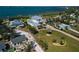 Expansive aerial view showcases lush landscaping, waterfront access, and a desirable neighborhood setting at 764 S Mccall Rd, Englewood, FL 34223