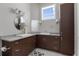 Spacious bathroom with dual sinks, granite countertops, wood cabinets, and ample storage for a luxurious feel at 764 S Mccall Rd, Englewood, FL 34223