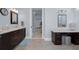 Beautiful bathroom featuring double sinks, with dark wood cabinets, marble countertops, and tile floors at 764 S Mccall Rd, Englewood, FL 34223