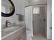 Updated bathroom featuring a decorative mirror and a tiled walk-in shower at 764 S Mccall Rd, Englewood, FL 34223
