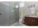 Bathroom featuring a glass shower enclosure, sleek fixtures, and granite countertops for a spa-like retreat at 764 S Mccall Rd, Englewood, FL 34223