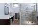 Bright bathroom with a glass shower and a vanity with a makeup counter area, as well as marble tile flooring at 764 S Mccall Rd, Englewood, FL 34223