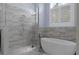 Modern bathroom featuring walk-in shower and free standing tub at 764 S Mccall Rd, Englewood, FL 34223