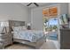 Cozy bedroom featuring a coastal theme, fan, and a door leading to an outdoor patio with a waterfront view at 764 S Mccall Rd, Englewood, FL 34223