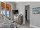 Bedroom featuring neutral tones, balcony access, and a walk-in closet, creating a serene and functional living space at 764 S Mccall Rd, Englewood, FL 34223