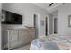Bedroom with a dresser, TV and ensuite bathroom access at 764 S Mccall Rd, Englewood, FL 34223