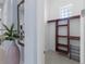 Hallway view of closet featuring wooden shelves at 764 S Mccall Rd, Englewood, FL 34223