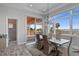 Bright dining room with elegant chandelier, water view, and sliding doors to the outdoor space at 764 S Mccall Rd, Englewood, FL 34223