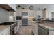 Gourmet kitchen featuring stainless steel appliances, granite countertops, and custom white cabinetry at 764 S Mccall Rd, Englewood, FL 34223