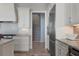 Elegant kitchen with white cabinetry, granite countertops, stainless appliances, and stylish backsplash at 764 S Mccall Rd, Englewood, FL 34223