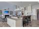 Open-concept kitchen and living room with a large island and a cozy fireplace at 764 S Mccall Rd, Englewood, FL 34223