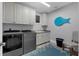 Well-equipped laundry room featuring modern washer and dryer units, ample cabinetry, and stylish decor at 764 S Mccall Rd, Englewood, FL 34223