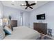 Well-lit main bedroom features two dressers and ceiling fan at 764 S Mccall Rd, Englewood, FL 34223