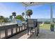 An outdoor kitchen with a built-in grill and a granite countertop overlooking a beautiful ocean view at 764 S Mccall Rd, Englewood, FL 34223