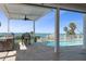 Seamless indoor/outdoor living featuring an outdoor kitchen, dining, a covered patio and a stunning water view at 764 S Mccall Rd, Englewood, FL 34223