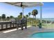Outdoor living area with an outdoor kitchen, a swimming pool, and ocean views at 764 S Mccall Rd, Englewood, FL 34223