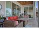 Stylish covered patio with comfortable seating and sliding glass doors at 764 S Mccall Rd, Englewood, FL 34223