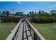 Picturesque view of a private wooden pier leading to the bay at 764 S Mccall Rd, Englewood, FL 34223