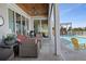 Resort-style patio with comfortable seating, an outdoor kitchen, and a sparkling pool at 764 S Mccall Rd, Englewood, FL 34223