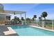 Outdoor pool with covered patio, grilling area, and waterfront view offers a relaxing retreat at 764 S Mccall Rd, Englewood, FL 34223