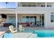 A luxurious pool with a tanning ledge and comfortable outdoor seating, with a view of the intercoastal waterway at 764 S Mccall Rd, Englewood, FL 34223