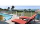 Outdoor swimming pool overlooking the ocean, complimented with lounge chairs and mature palm trees at 764 S Mccall Rd, Englewood, FL 34223