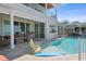 Resort-style pool with a tanning ledge, outdoor seating, and a covered patio, perfect for entertaining at 764 S Mccall Rd, Englewood, FL 34223