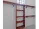 Walk-in closet with custom wood shelving for organized storage at 764 S Mccall Rd, Englewood, FL 34223
