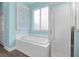 Bright bathroom featuring a soaking tub and a glass enclosed walk-in shower at 2905 Hammock Vista Ct, Plant City, FL 33566