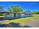 Well-maintained exterior with covered patio and large backyard at 3212 Cork Rd, Plant City, FL 33565