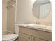 Bathroom featuring a vanity with a round mirror and a shower-tub combination at 14663 Norwood Oaks Dr # 103, Tampa, FL 33613