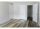 Bedroom with modern laminate flooring, closet, and doors that provide ample storage and accessibility at 14663 Norwood Oaks Dr # 103, Tampa, FL 33613