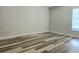 Bedroom with modern laminate flooring and a window that lets in natural light at 14663 Norwood Oaks Dr # 103, Tampa, FL 33613