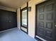 Covered entrance area with tile flooring and an exterior light fixture at 14663 Norwood Oaks Dr # 103, Tampa, FL 33613