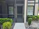 Screened entryway with neutral colors, landscaping, and a storm door for added security at 14663 Norwood Oaks Dr # 103, Tampa, FL 33613