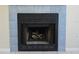 Fireplace with decorative blue tile surround and a metal grate at 14663 Norwood Oaks Dr # 103, Tampa, FL 33613