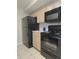 Kitchen featuring black appliances, light cabinets, and tile flooring at 14663 Norwood Oaks Dr # 103, Tampa, FL 33613