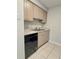 Updated kitchen area with stainless steel sink, neutral cabinets, and tile flooring at 14663 Norwood Oaks Dr # 103, Tampa, FL 33613