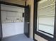 Laundry room with a washer and dryer and an open door, complete with natural light through a nearby window at 14663 Norwood Oaks Dr # 103, Tampa, FL 33613