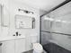 Modern bathroom features updated vanity, toilet, and glass-enclosed walk-in shower at 1814 Tarah Trace Dr, Brandon, FL 33510