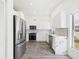 Modern kitchen with stainless steel appliances, stone countertops, and gray backsplash at 1814 Tarah Trace Dr, Brandon, FL 33510