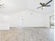 Bright open-concept living room with gray flooring, ceiling fan, and sliding glass doors at 1814 Tarah Trace Dr, Brandon, FL 33510