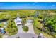 Gorgeous riverfront home with lush landscaping, a private dock, and long driveway at 283 Hilltop Cir, Punta Gorda, FL 33982