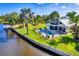 Stunning waterfront home featuring a pool, screened lanai, lush landscaping, and private dock at 283 Hilltop Cir, Punta Gorda, FL 33982